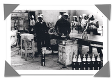 Black and white image of sailors working with ammunition on a navy ship